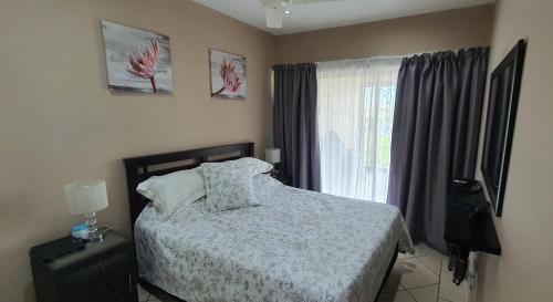 a bedroom with a bed and a window at Sea Breeze West in Margate