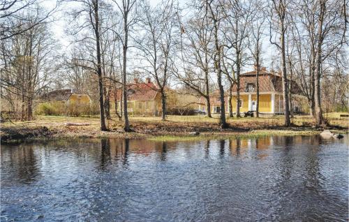 a house next to a river with a house at 4 Bedroom Gorgeous Home In Lindesberg in Lindesberg