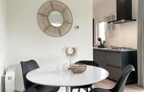 a white table and chairs in a kitchen with a mirror at 2 Bedroom Stunning Home In Heinkenszand in Heinkensand
