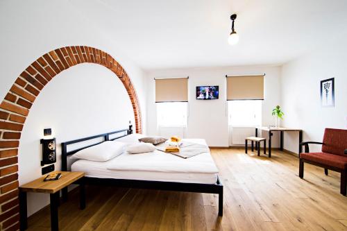 a bedroom with a bed with an archway at Old Parish House in Bled