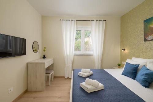 a bedroom with a bed with two towels on it at Villa Putina by IstriaLux in Svetvinčenat
