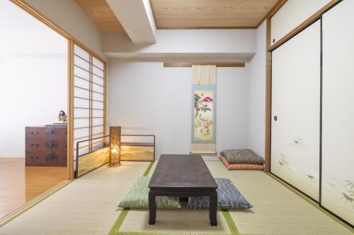 a room with a table in the middle of it at Komorebi in Tokyo