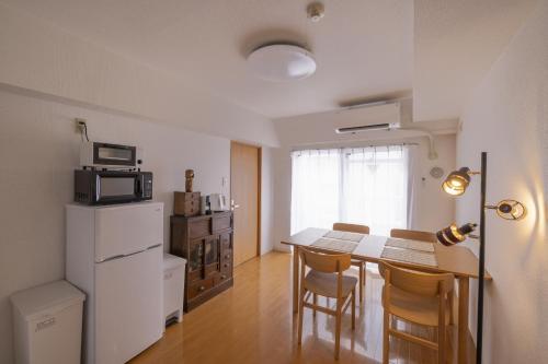 a kitchen and dining room with a table and chairs at Komorebi in Tokyo
