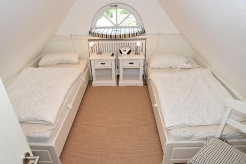 En eller flere senge i et værelse på Residenz Üüs Ailön