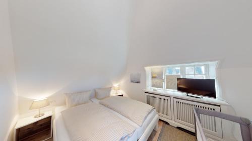 En eller flere senge i et værelse på Landhaus Strandhafer HT 2