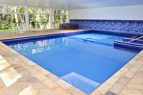a large swimming pool with blue water at Hotel Termas Gravatal in Gravatal