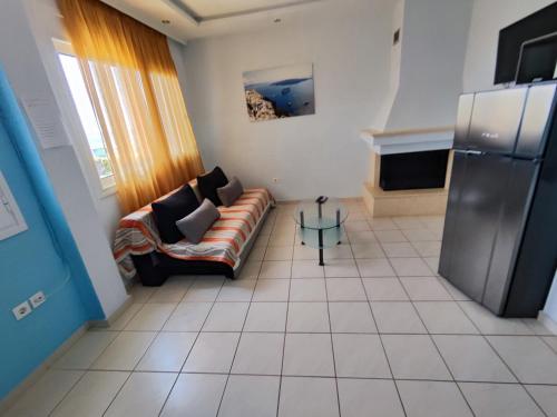 a living room with a couch and a table at Seaside house in Sozopoli