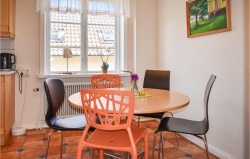 a dining room with a table and chairs and a window at Awesome Home In Tomelilla With Wifi in Tomelilla