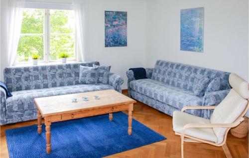 a living room with a couch and a coffee table at Nice Home In Urshult With Wifi in Urshult