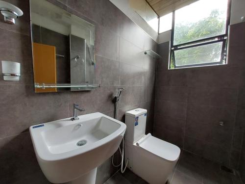 a bathroom with a sink and a toilet at Lake Wave Hotel in Anuradhapura