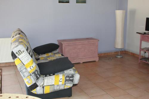 a couch sitting in a living room at La Bergerie du festel in Saint-Riquier