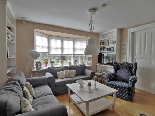 a living room with a couch and a table at Landhaus Westerweg - Familie Petersen in Wanderup