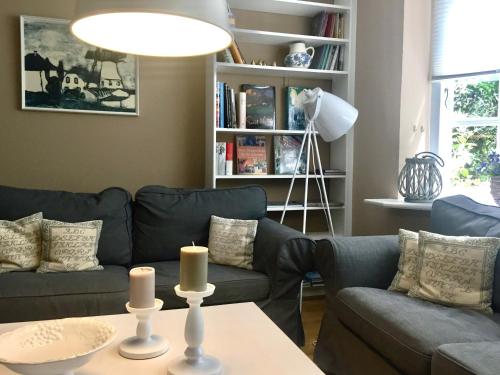 a living room with a couch and a table with candles at Landhaus Westerweg - Familie Petersen in Wanderup