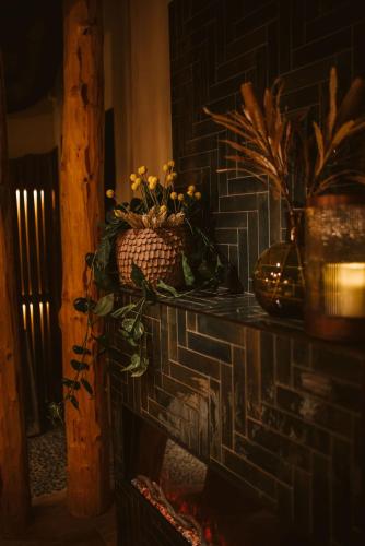 a brick fireplace with a vase of flowers on it at Best Western Plus Hus 57 in Ängelholm