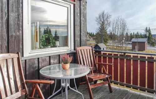 a patio with a table and two chairs and a window at Three-Bedroom Holiday Home In Sjusjoen in Sjusjøen