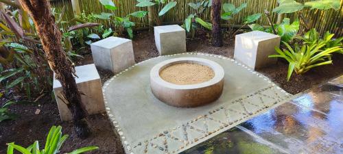 a concrete toilet in the middle of a garden at Dar Amane Guest House in Graskop
