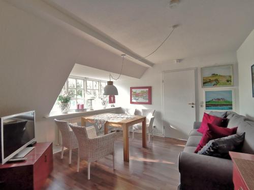 a living room with a table and a couch at Landhaus Westerweg - Familie Petersen in Wanderup