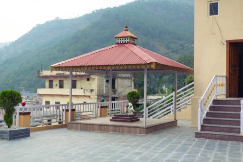 a gazebo with a roof on a building at Hotel Gyan Gauri Palace in Beni