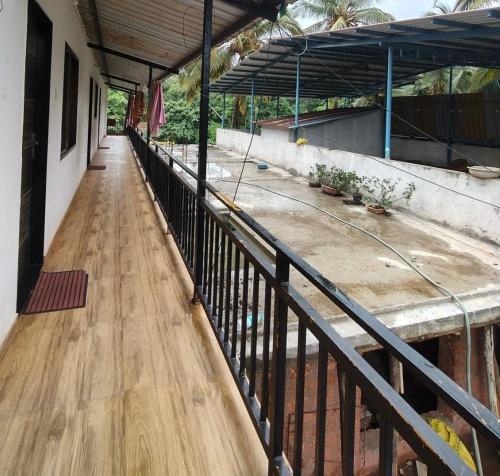 a hallway of a building with a wooden floor at Vickys Guest House in Malvan