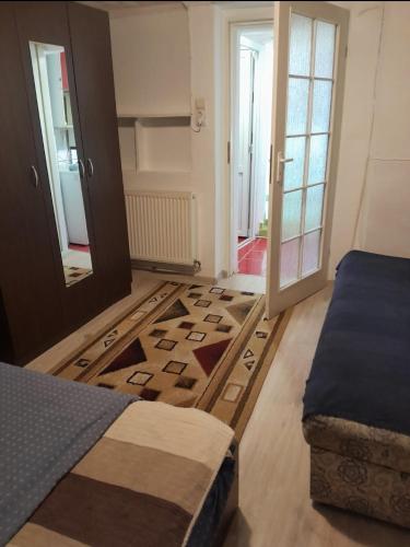 a bedroom with a bed and a rug on the floor at Farmec vintage2 in Cluj-Napoca