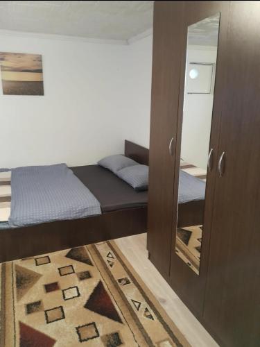 a small bedroom with a bed and a mirror at Farmec vintage2 in Cluj-Napoca