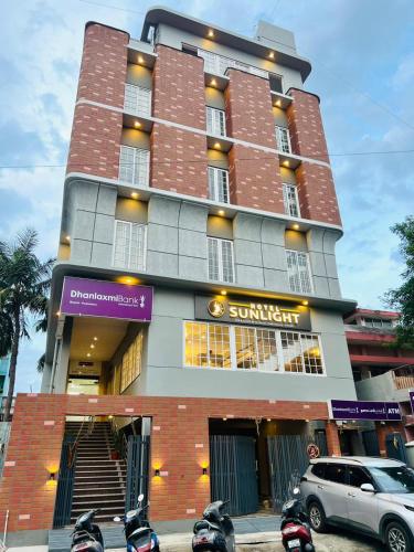 a building with motorcycles parked in front of it at Hotel Sunlight in Puducherry