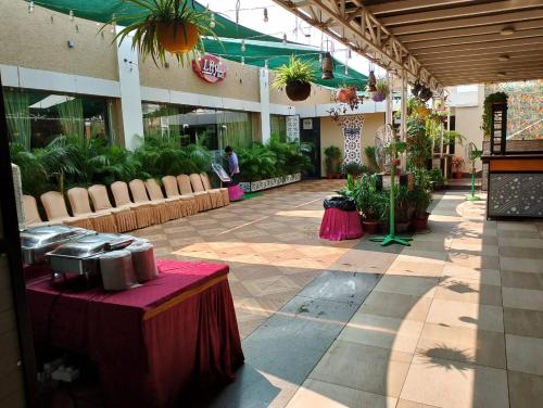 a building with a patio with potted plants in it at Hotel Pushpak in Bhubaneshwar