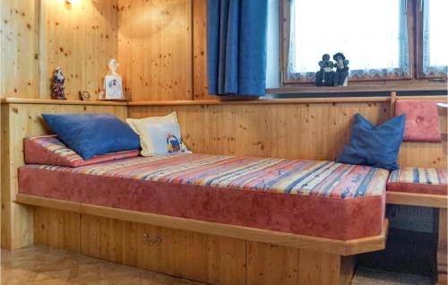 a wooden bed in a room with a window at Ferienwohnung - Hochgallzein in Gallzein