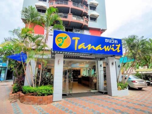 a sign for a hotel in front of a building at Tanawit Hotel Hua Hin in Hua Hin