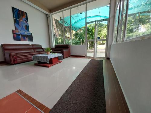 a living room with a couch and a table at Lake Wave Hotel in Anuradhapura