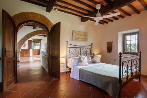 a bedroom with a bed and an arched doorway at Private Chianti Hill Residence in Vagliagli