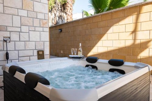 a jacuzzi tub with a table in it at I Love Baia Verde spa in Baia Verde