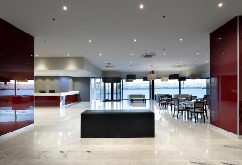 a lobby with a table and chairs in a building at Eurostars Zaragoza in Zaragoza