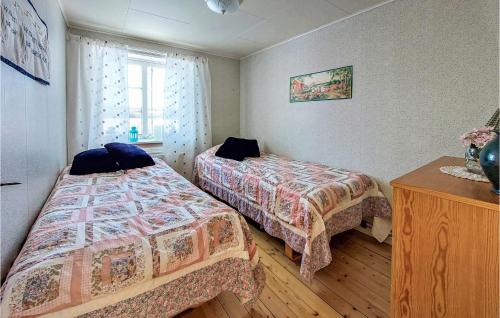 a bedroom with two beds and a wooden floor at 2 Bedroom Nice Home In Lönsboda in Lönsboda