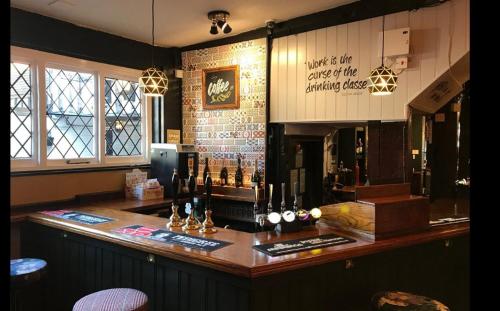 a bar with bottles of wine on top of it at The Bull Hotel in Ludlow