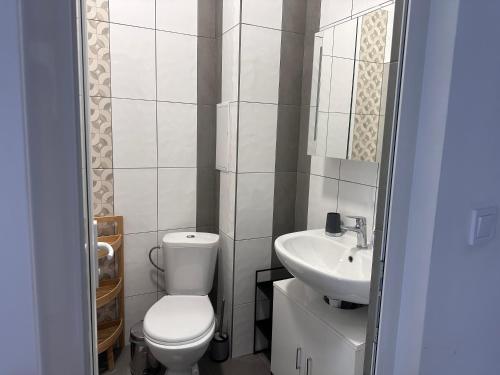 a small bathroom with a toilet and a sink at Doris Beach apartment D06 in Burgas City