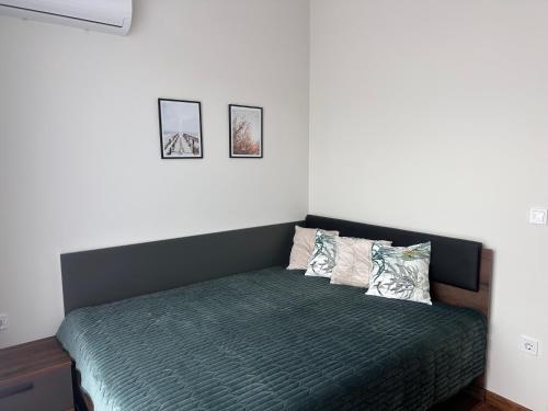 a bedroom with a bed with two pillows on it at Doris Beach apartment D06 in Burgas City