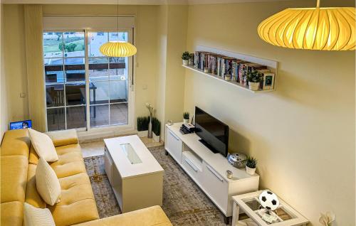 a living room with a couch and a tv at Nice Apartment In Benalmádena Costa in Benalmádena