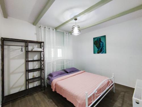 a bedroom with a bed and a ladder in it at Guest house of gnomes in Akhmety