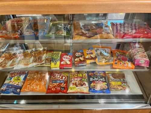a refrigerator filled with lots of different types of food at Peace INN HAGI in Hagi