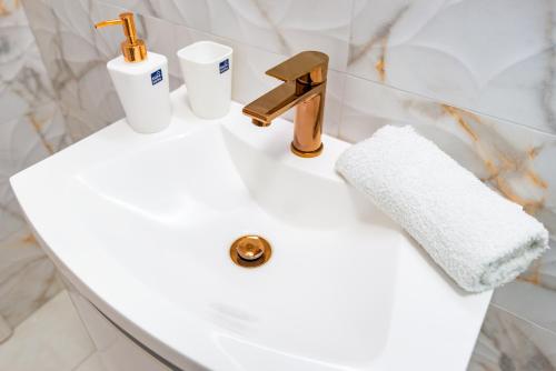 a bathroom sink with a faucet and two cups on it at Villa Zita Lovran in Opric