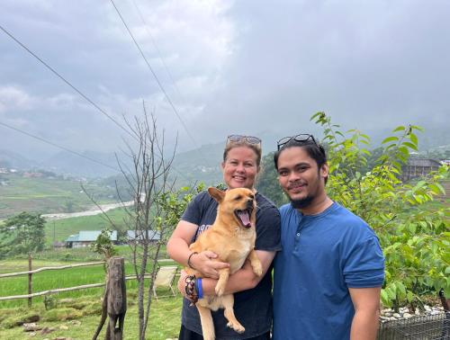 a man and a woman holding a dog at Pavi garden in Sa Pa