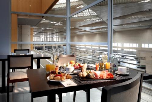 a table with food on it in a restaurant at Eurostars Zaragoza in Zaragoza
