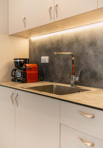 a kitchen with a sink and a counter top at Ydorilion Suites in Preveza