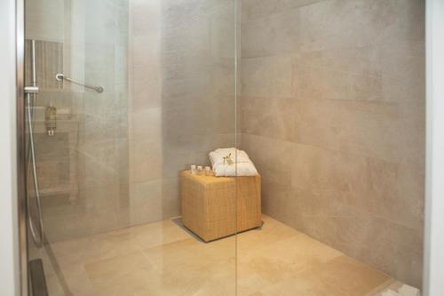 a shower with a glass door and a box at Myseahouse Flamingo - Adults Only 4* Sup in Playa de Palma