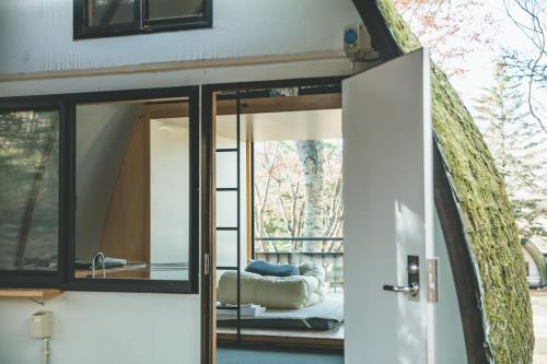 an open door of a tiny house with a living room at Tiny Garden Tateshina in Chino