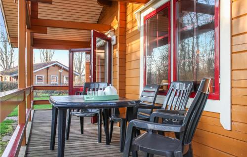 a porch with a table and chairs on it at 3 Bedroom Cozy Home In Gramsbergen in Gramsbergen