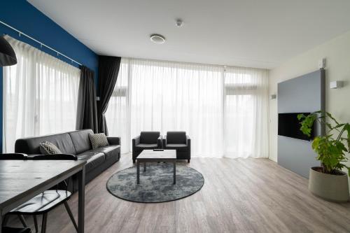 a living room with a couch and a table at YAYS Amsterdam Prince Island by Numa in Amsterdam