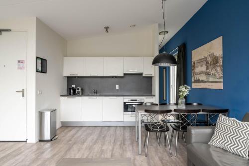a kitchen and living room with a table and chairs at YAYS Amsterdam Prince Island by Numa in Amsterdam