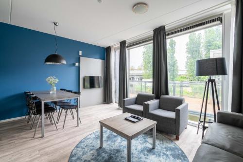 a living room with a couch and a table at YAYS Amsterdam Prince Island by Numa in Amsterdam